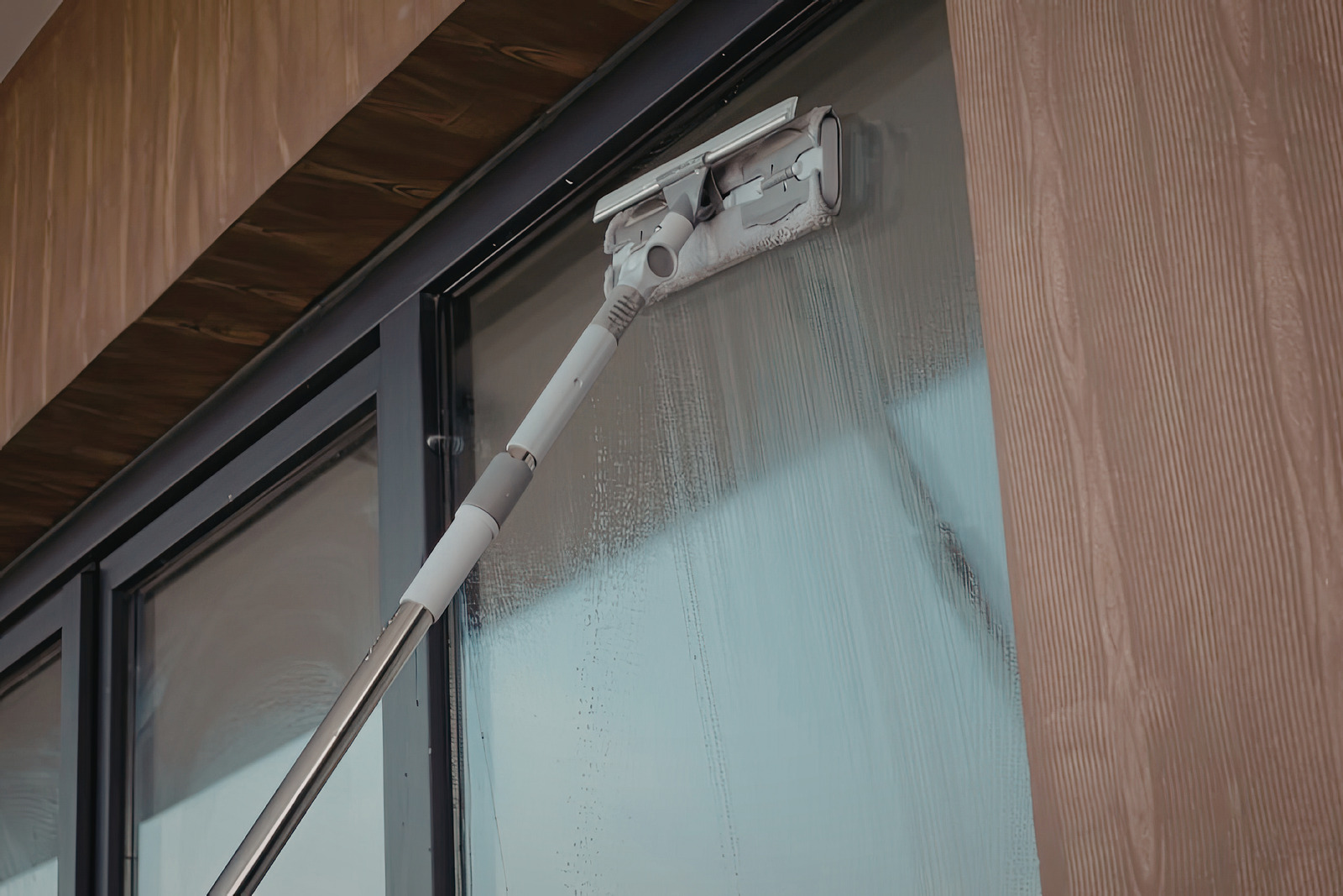Telescopic pole washing exterior window glass